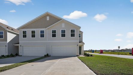 A white house with a driveway.