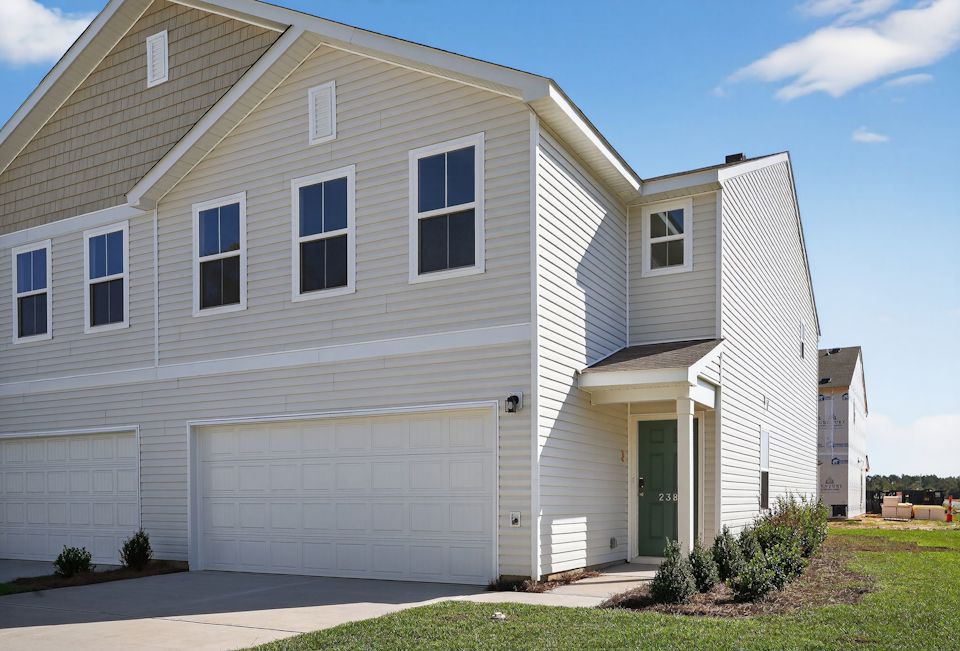 A white house with a garage.