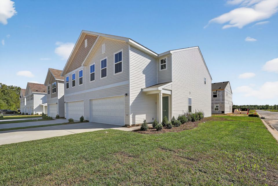 A white house with a garage.