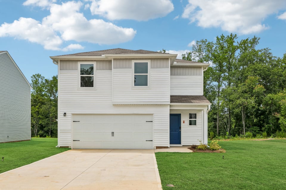 A white house with a garage.