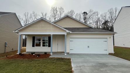 A house with garages and grass.