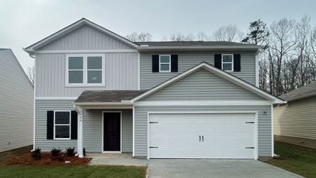 A house with a garage with American Gothic House in the background.