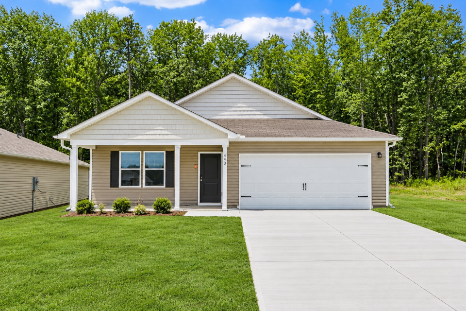 A house with a garage with Little White House in the background.