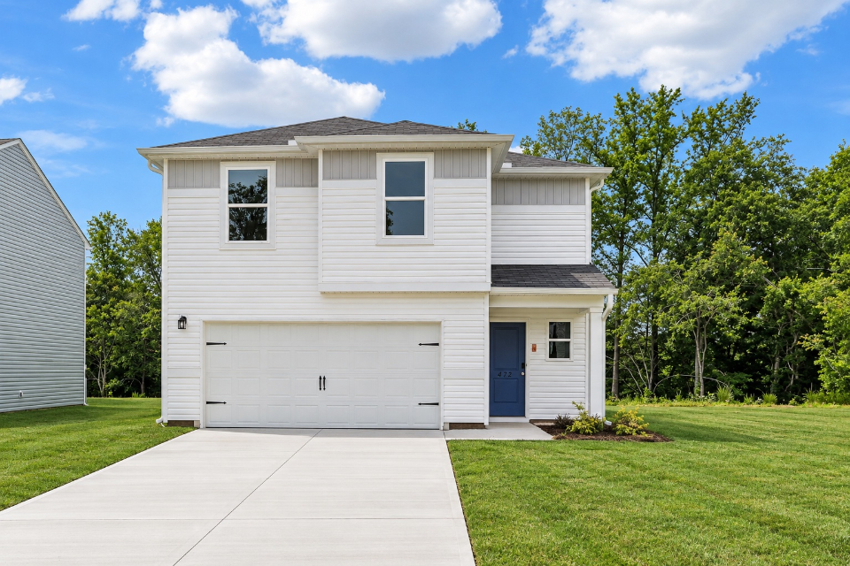 A white house with a garage.