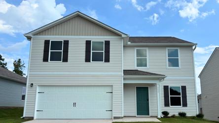 A white house with a garage.
