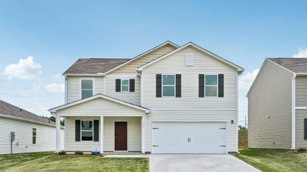 A white house with a garage.