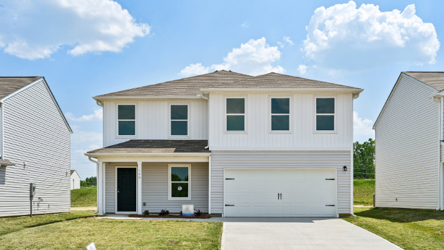 A house with garages and grass.