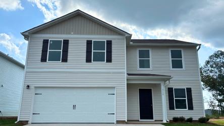 A white house with a garage.