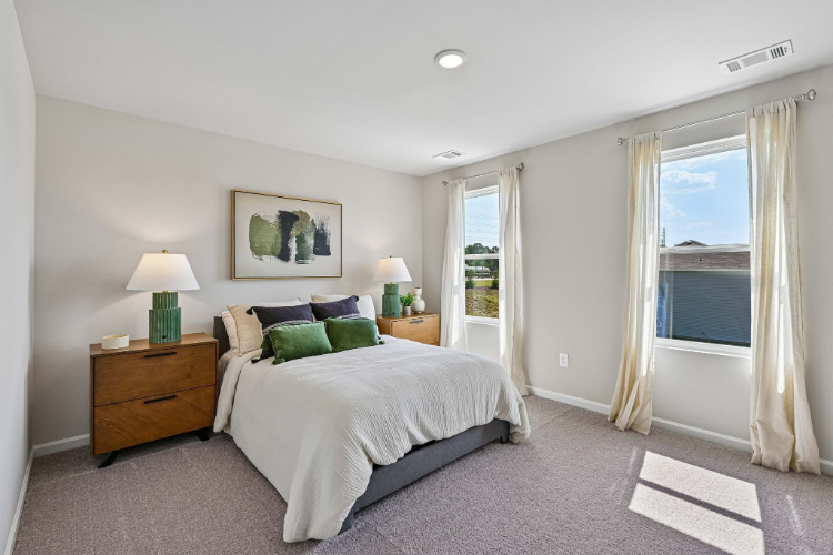 A bedroom with a bed and a window.