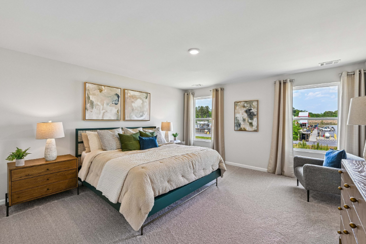 A bedroom with a large window.