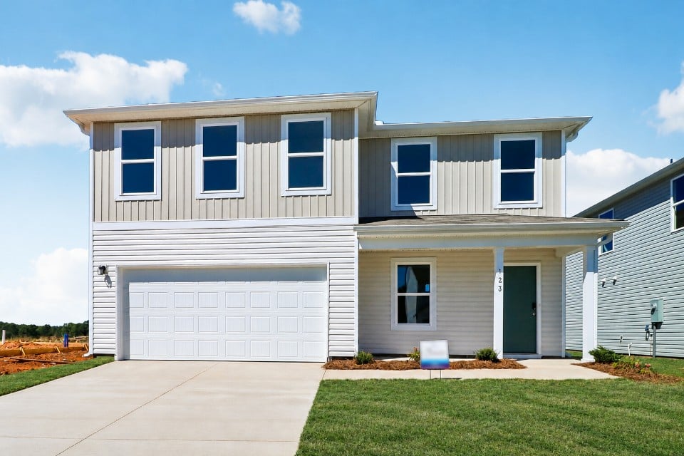 A white house with a garage.