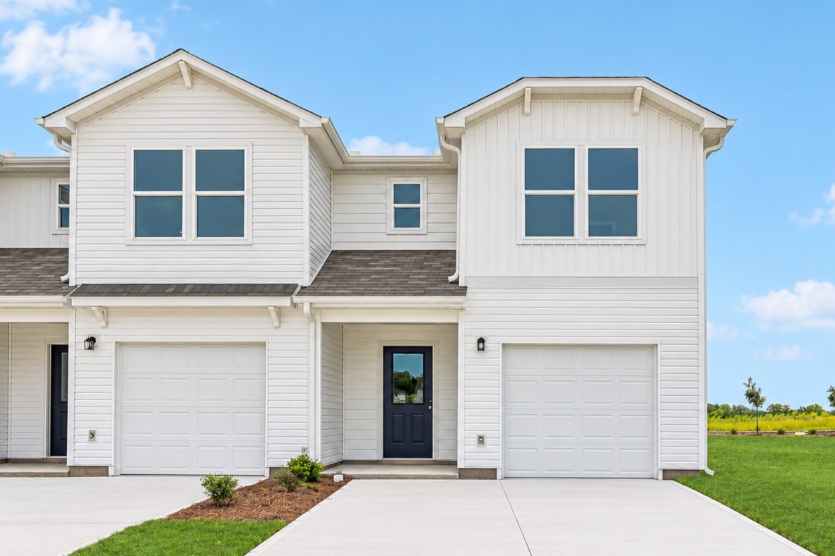A white house with garages.