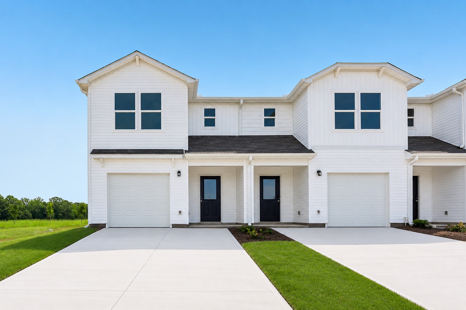 A white house with garages.