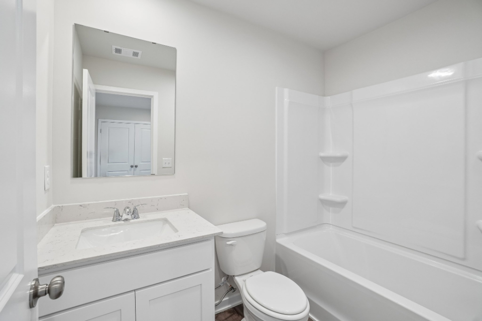 A bathroom with a toilet and sink.