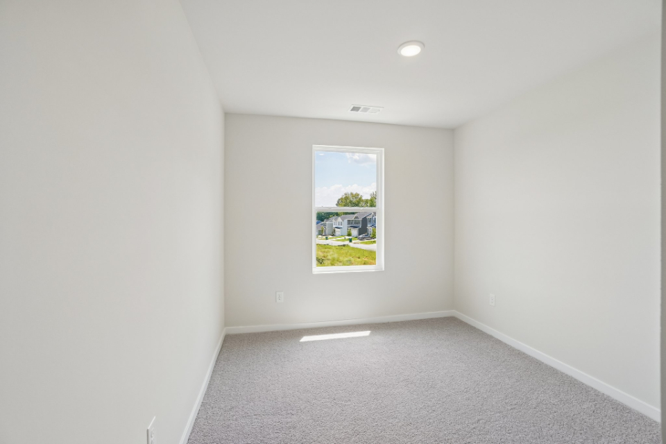 A white room with a painting on the wall.