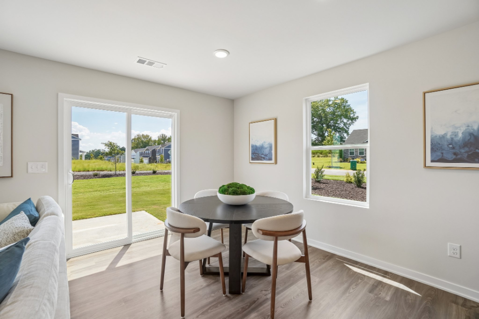 A room with a table and chairs.