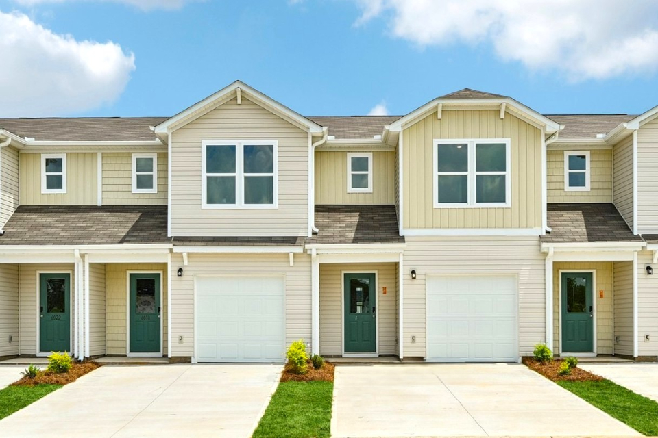 A house with garages and a driveway.