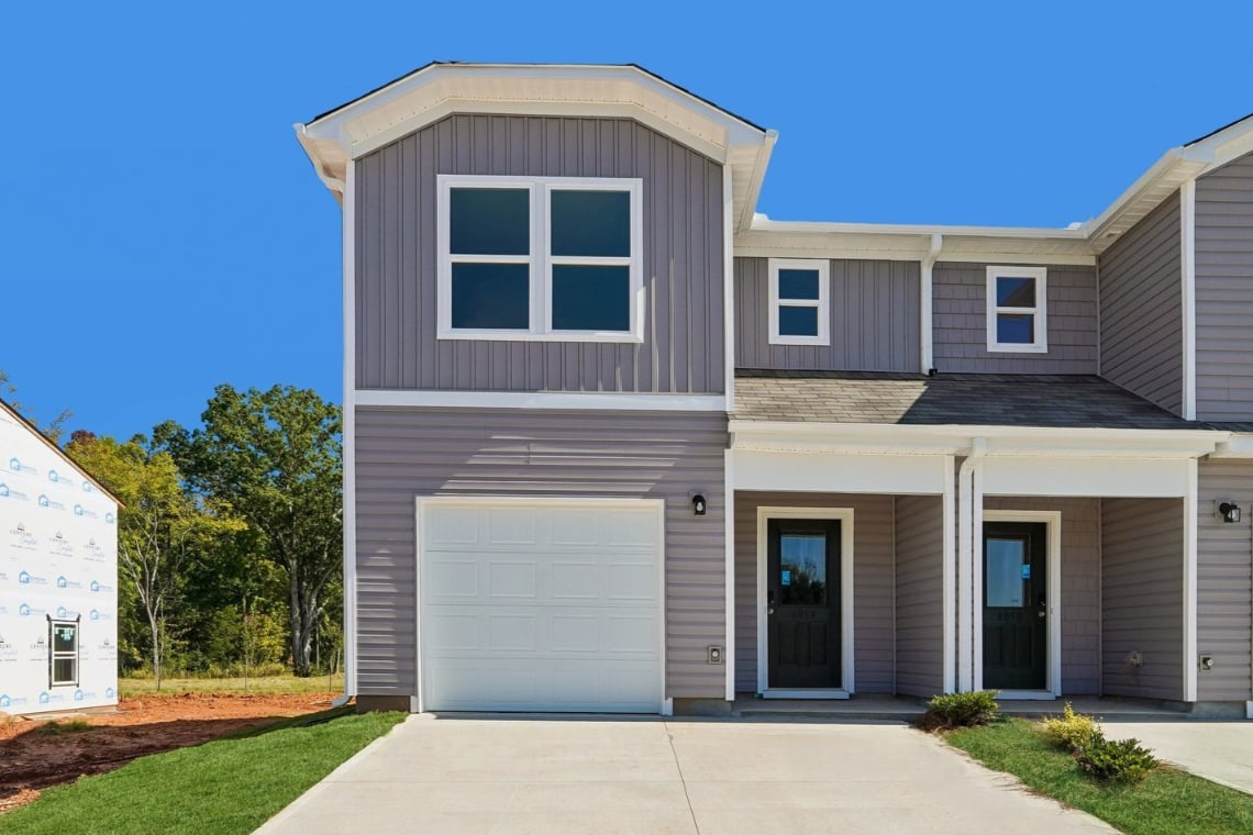 A house with garages and a driveway.