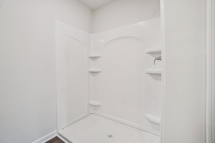 A white bathroom with a glass shower.