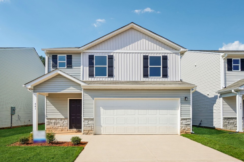 A white house with a garage.