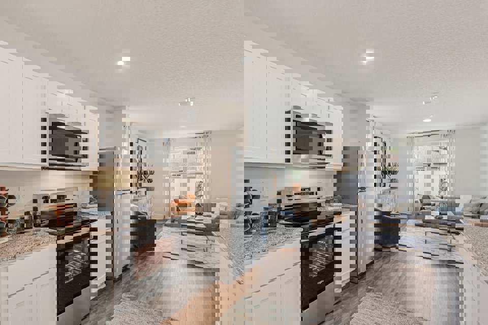 A kitchen with white cabinets.