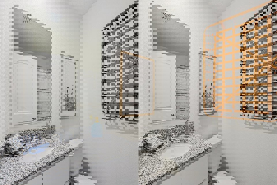 A bathroom with a sink and a mirror.