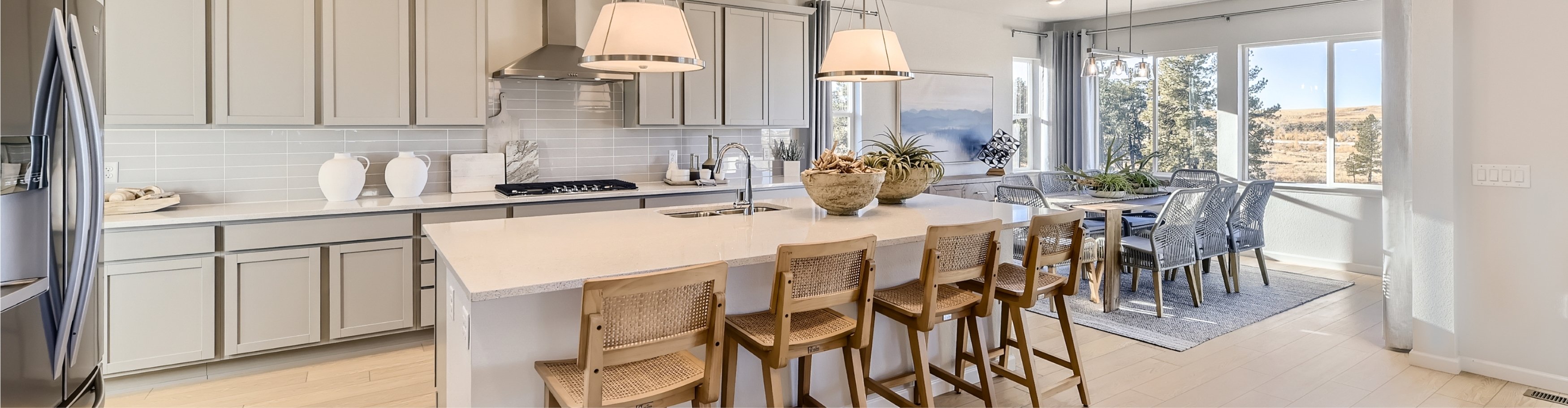 A kitchen with a dining table and chairs.