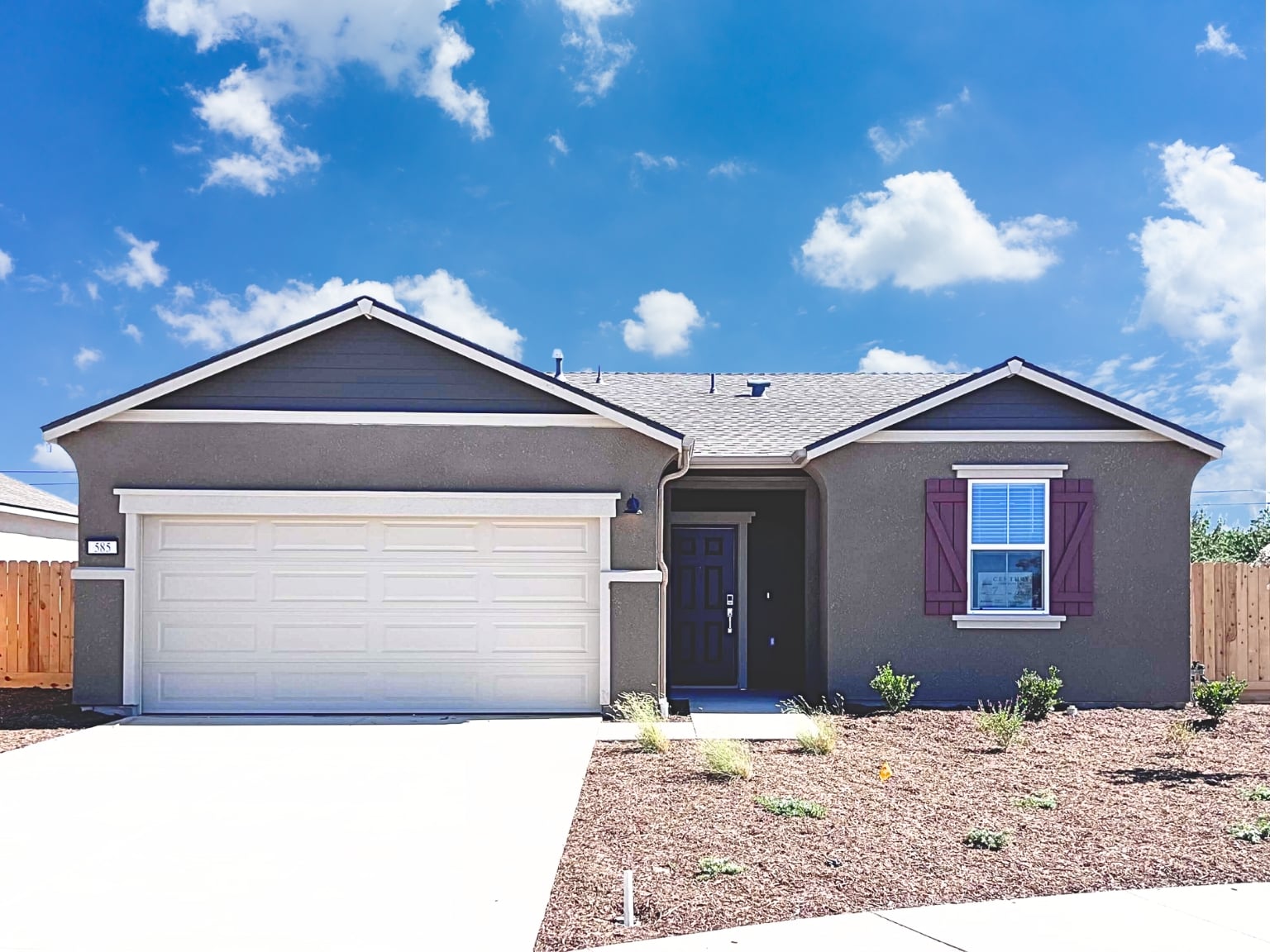 A house with garages and a fence.