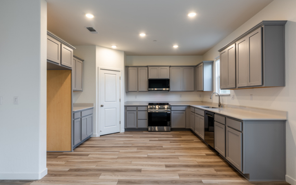 A kitchen with white cabinets.