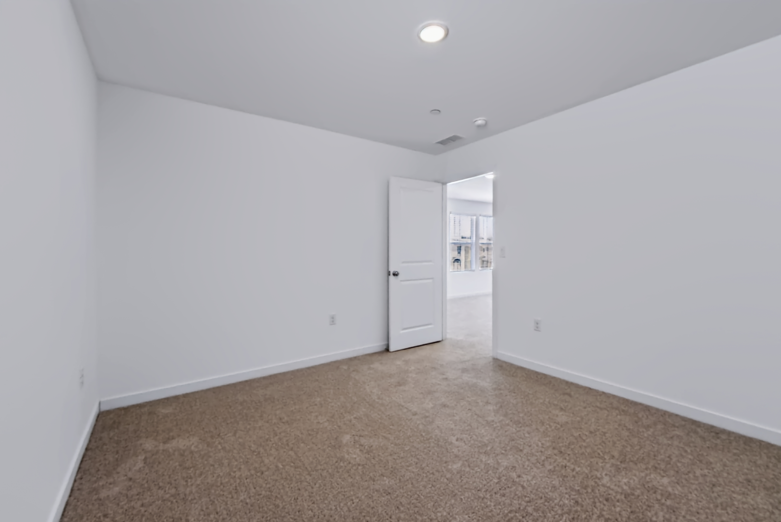 A hallway with white walls.