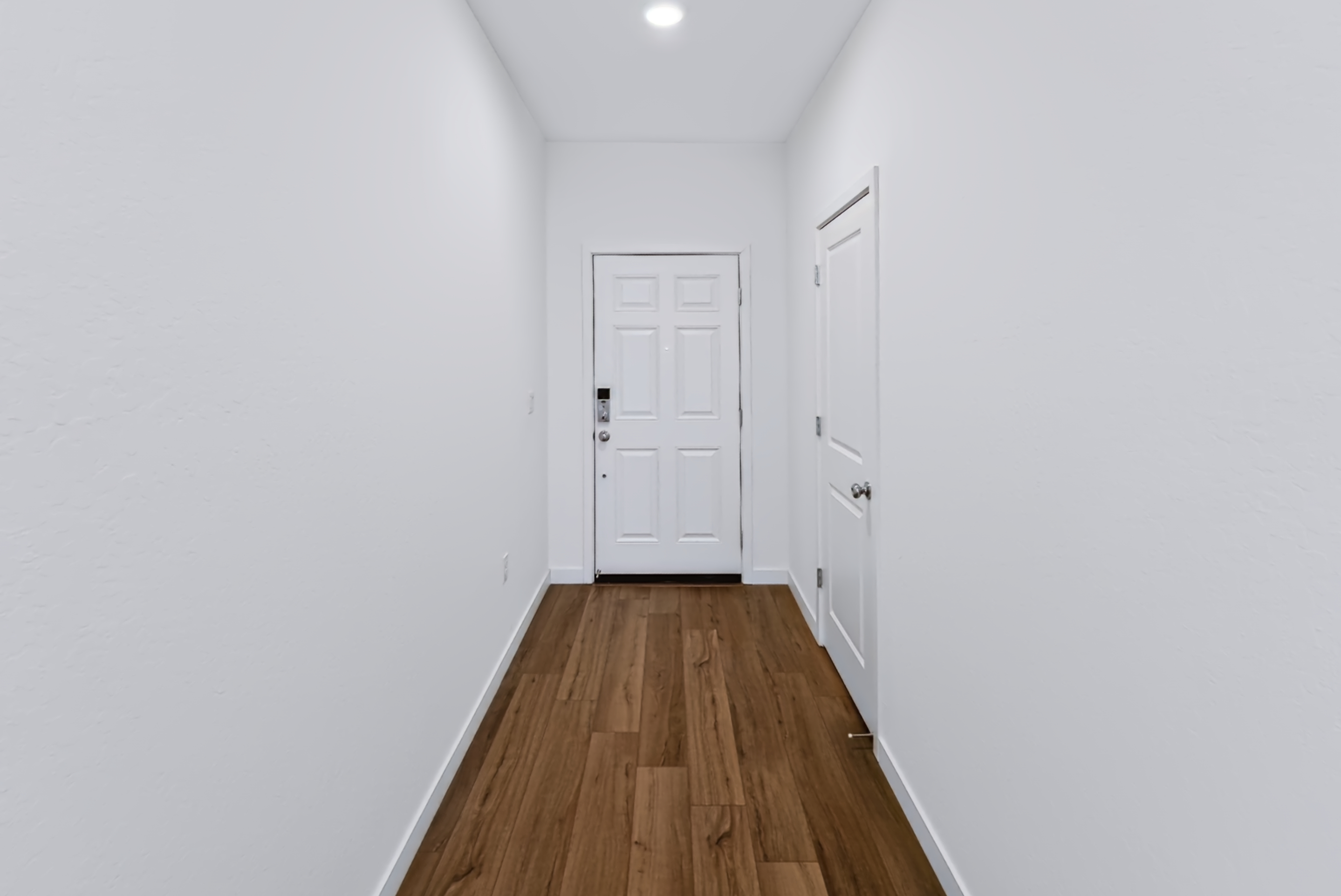 A hallway with white doors.