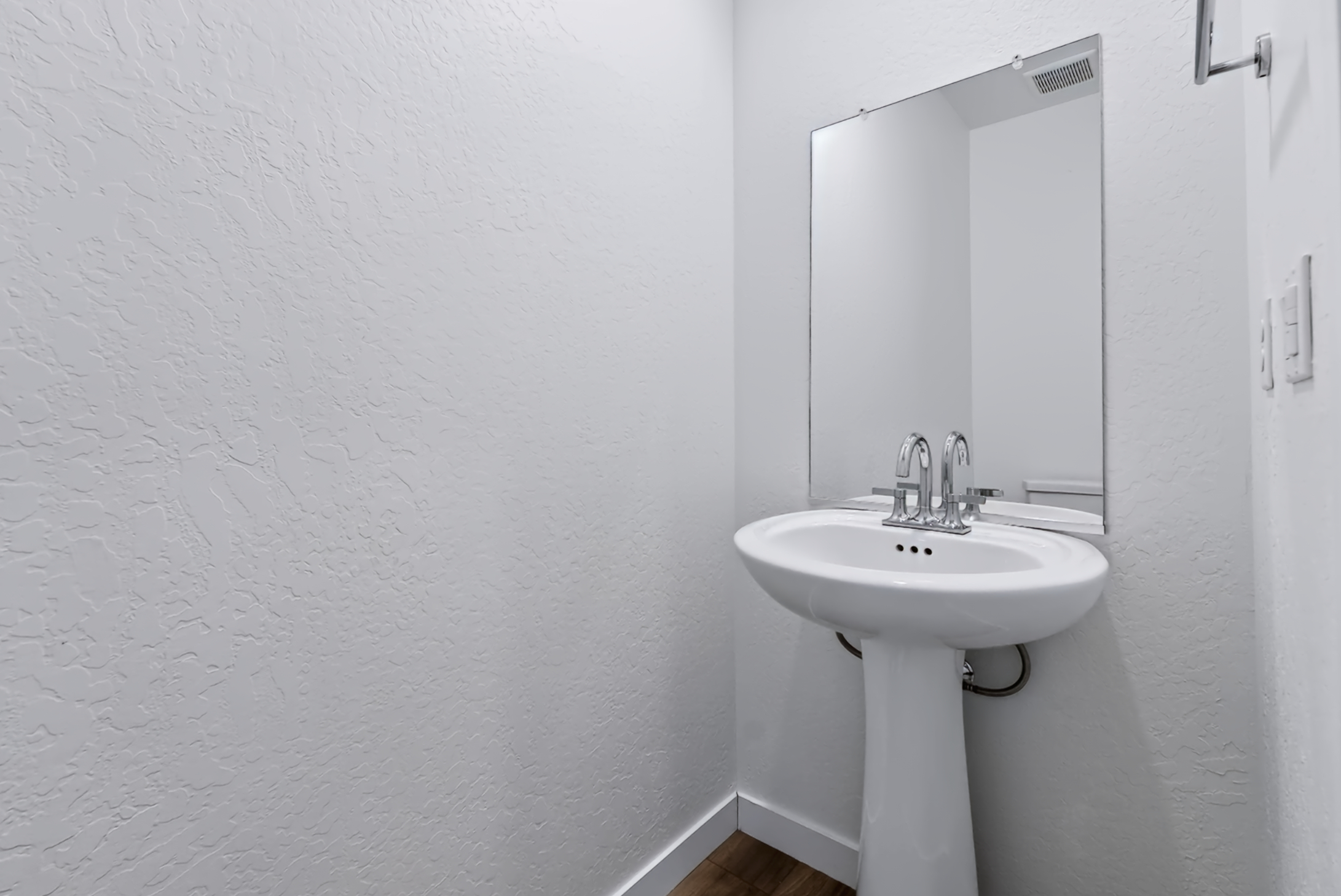 A bathroom with a mirror and sink.