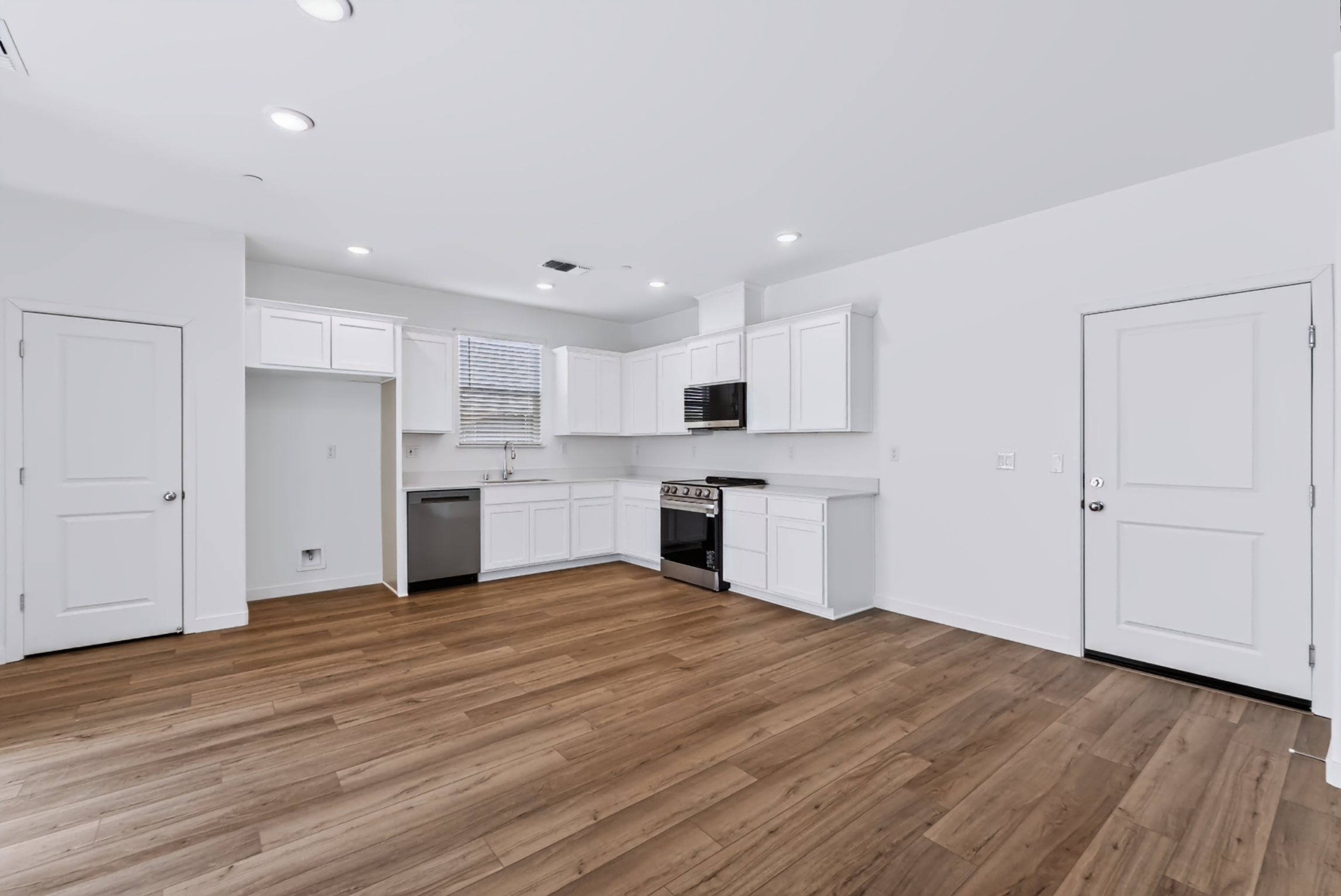 A large kitchen with white cabinets.