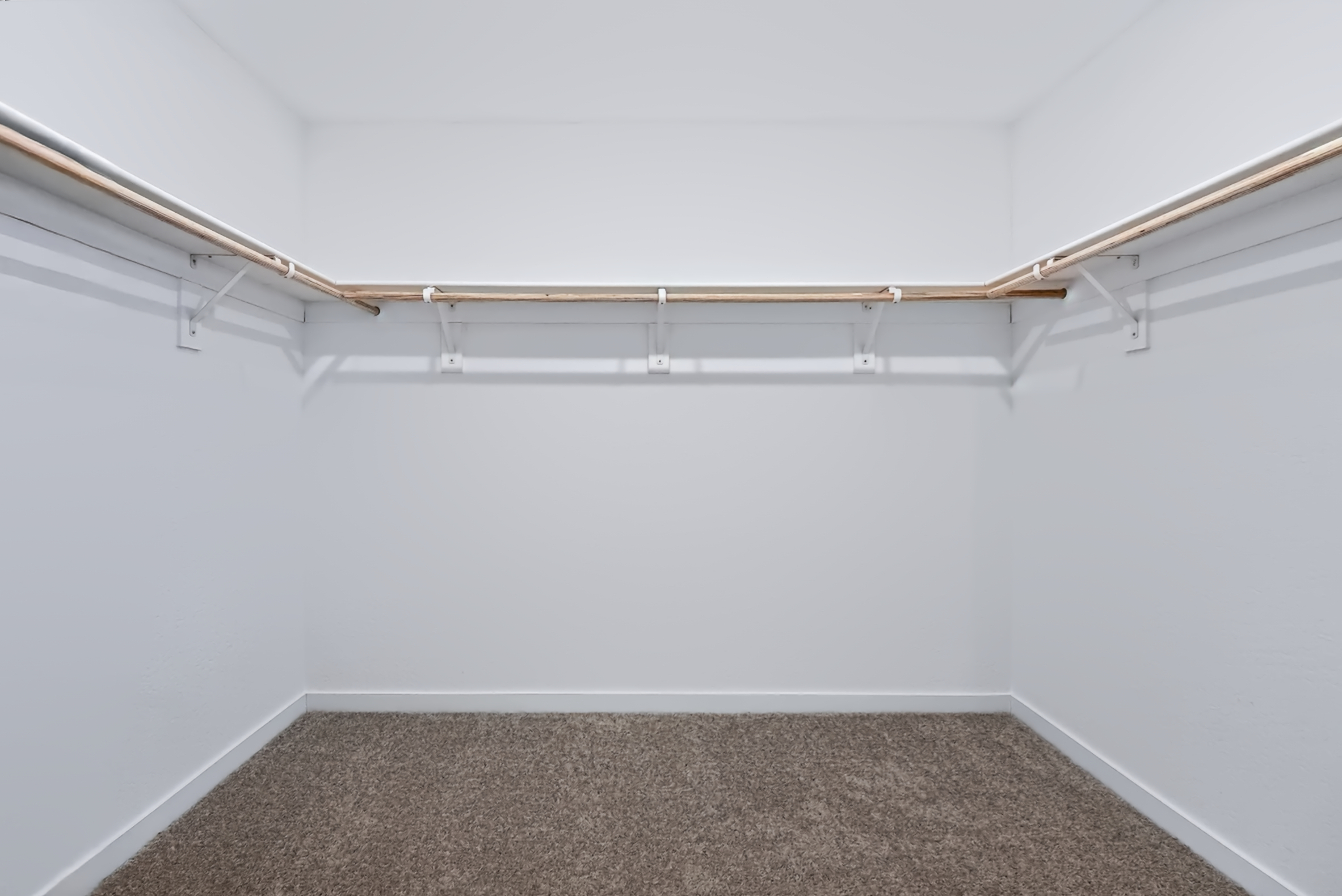 A white wall with a carpet.