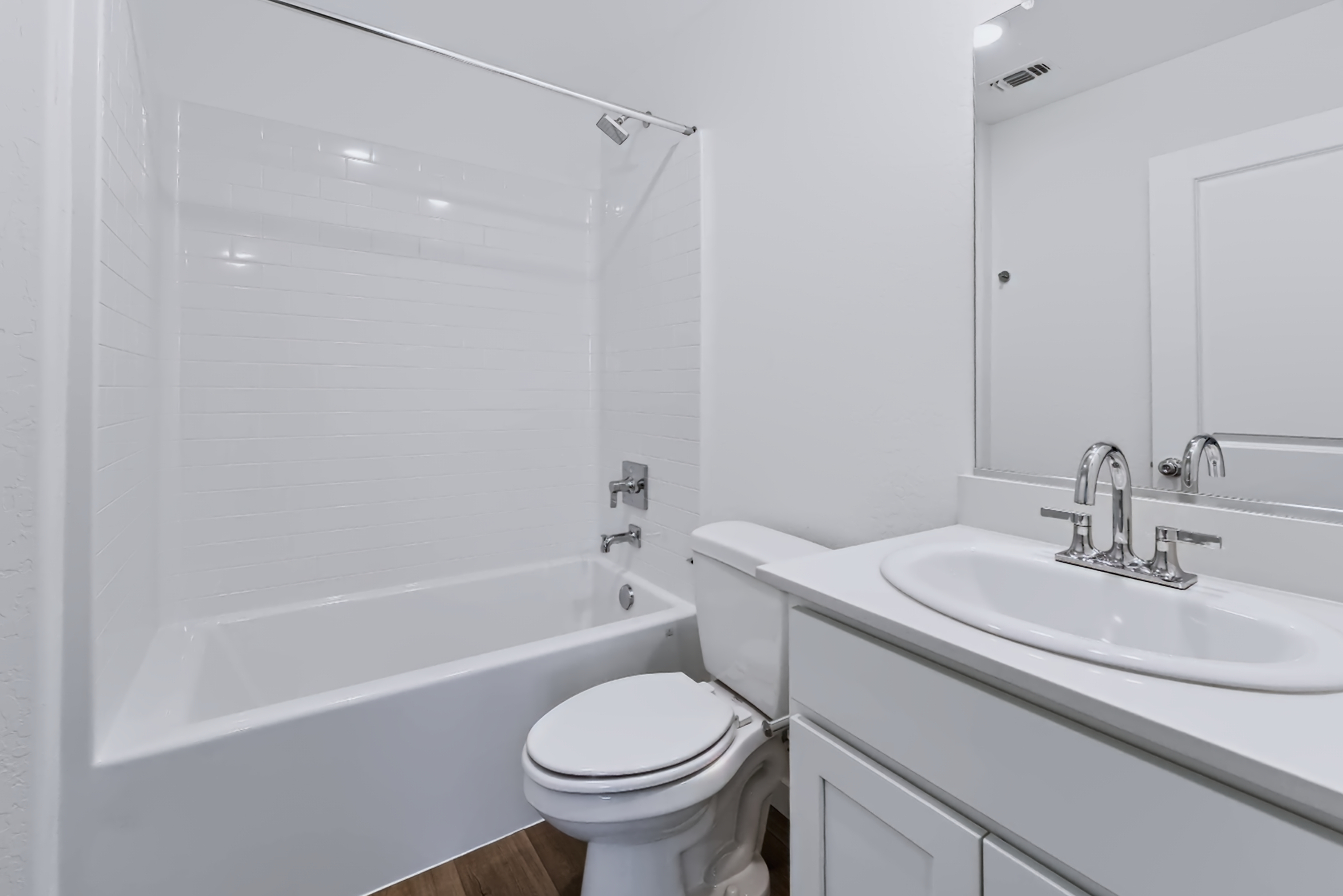 A bathroom with a sink toilet and bathtub.