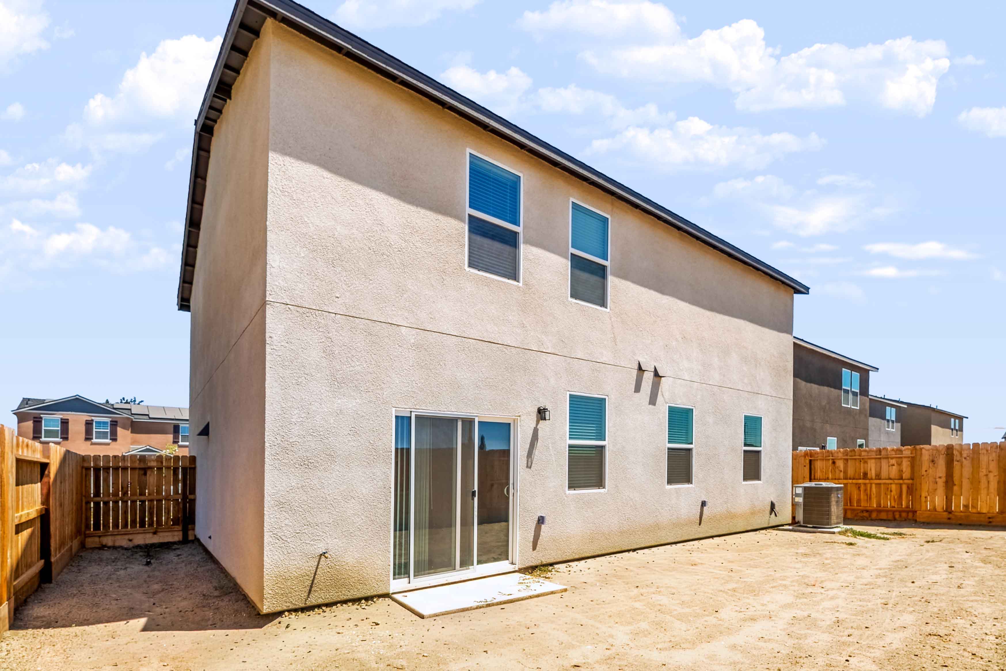 A white building with a fence.