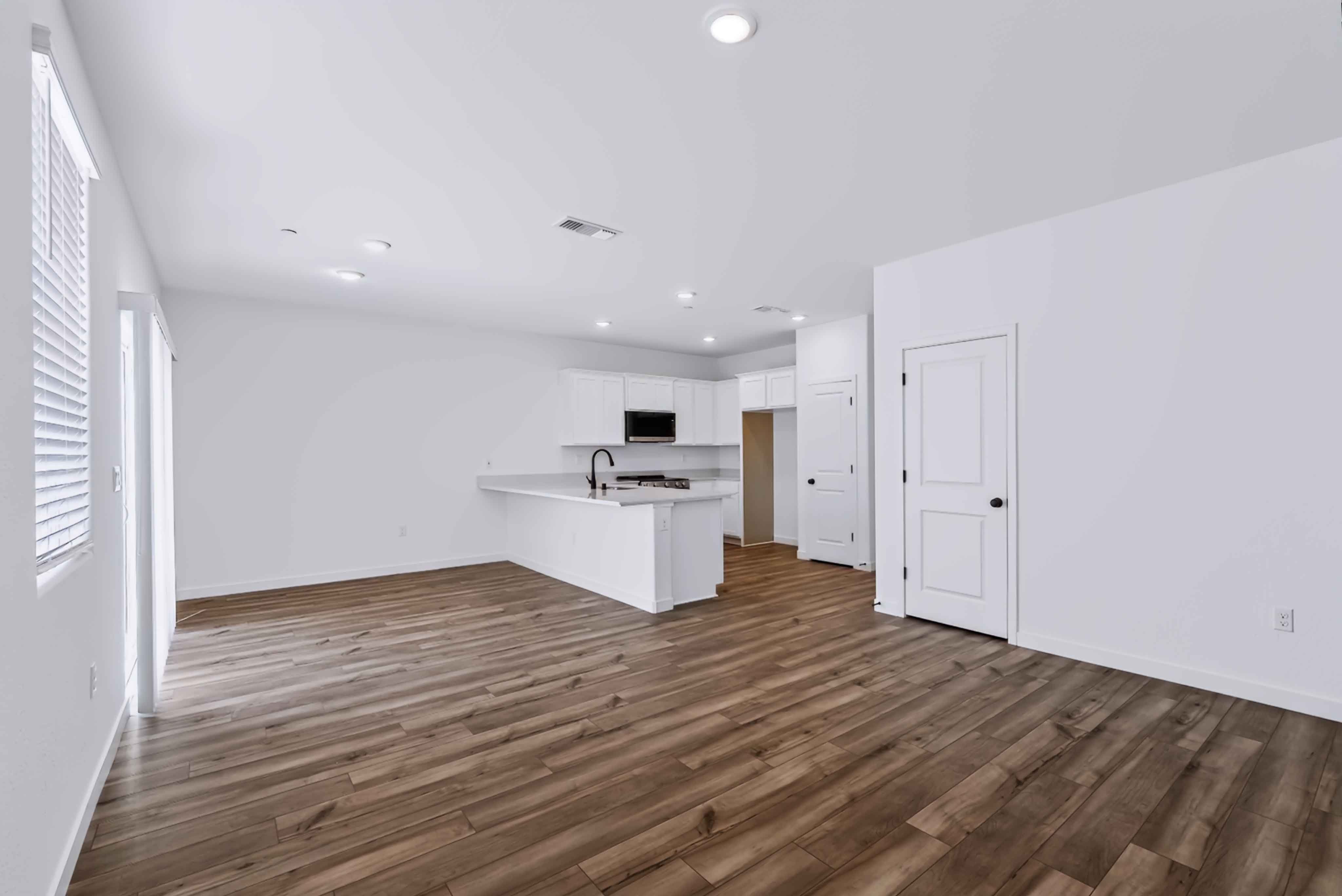 A kitchen with white cabinets.