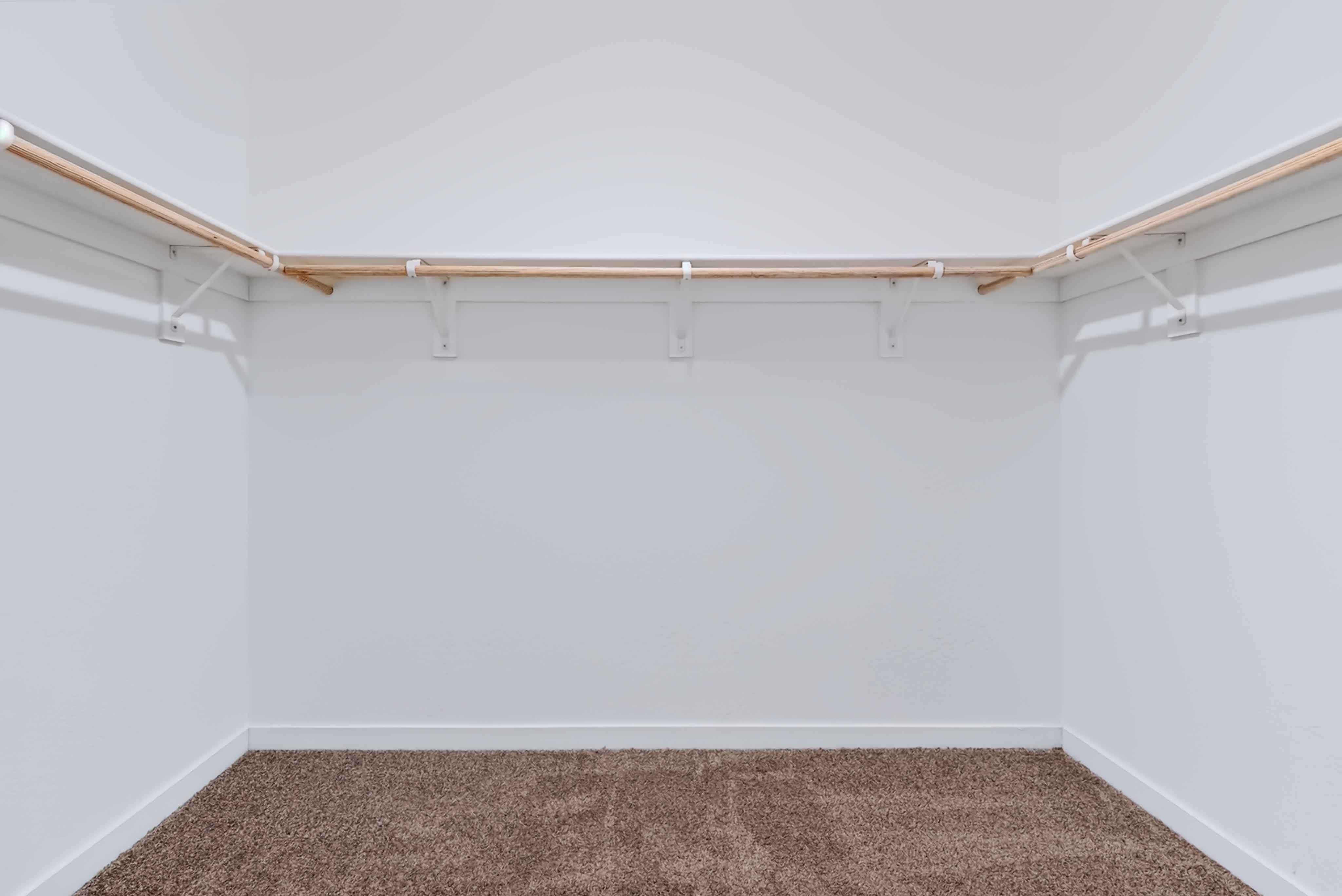 A room with a carpet and a wood floor.
