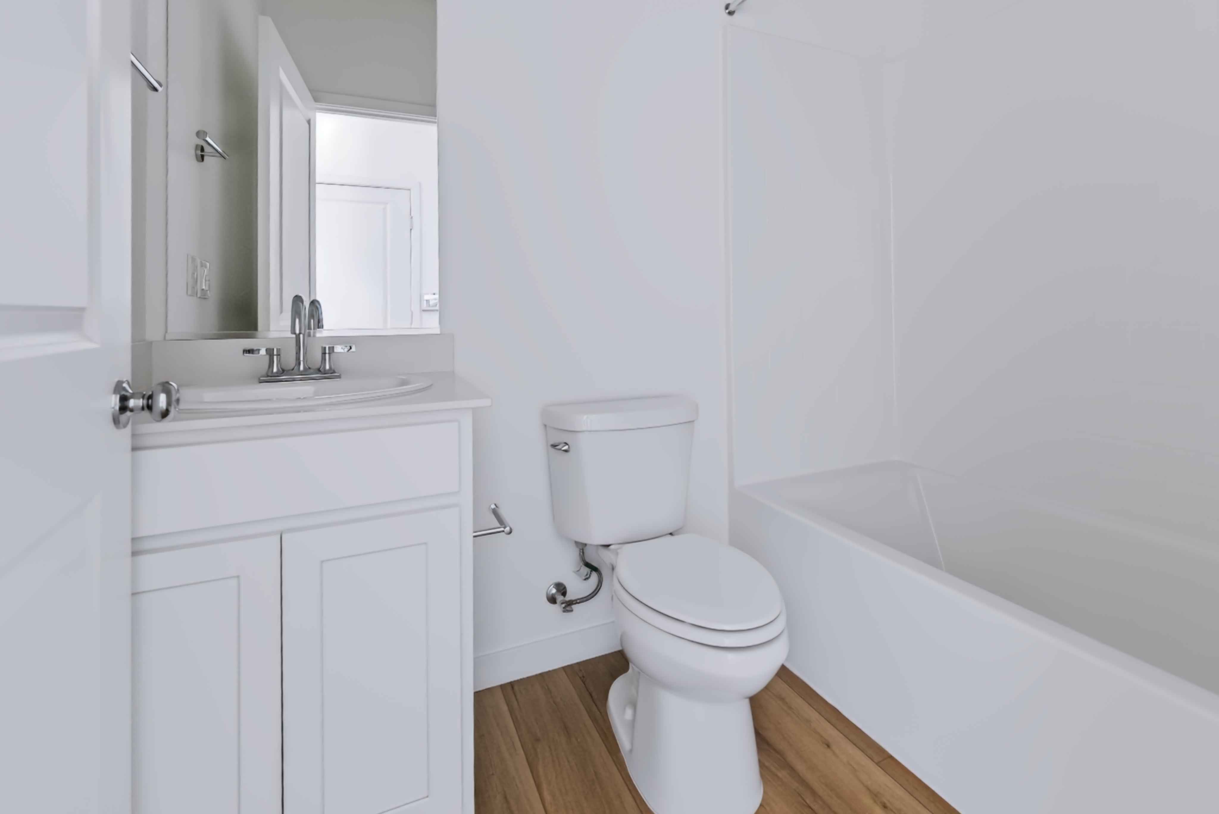 A bathroom with a toilet and bathtub.