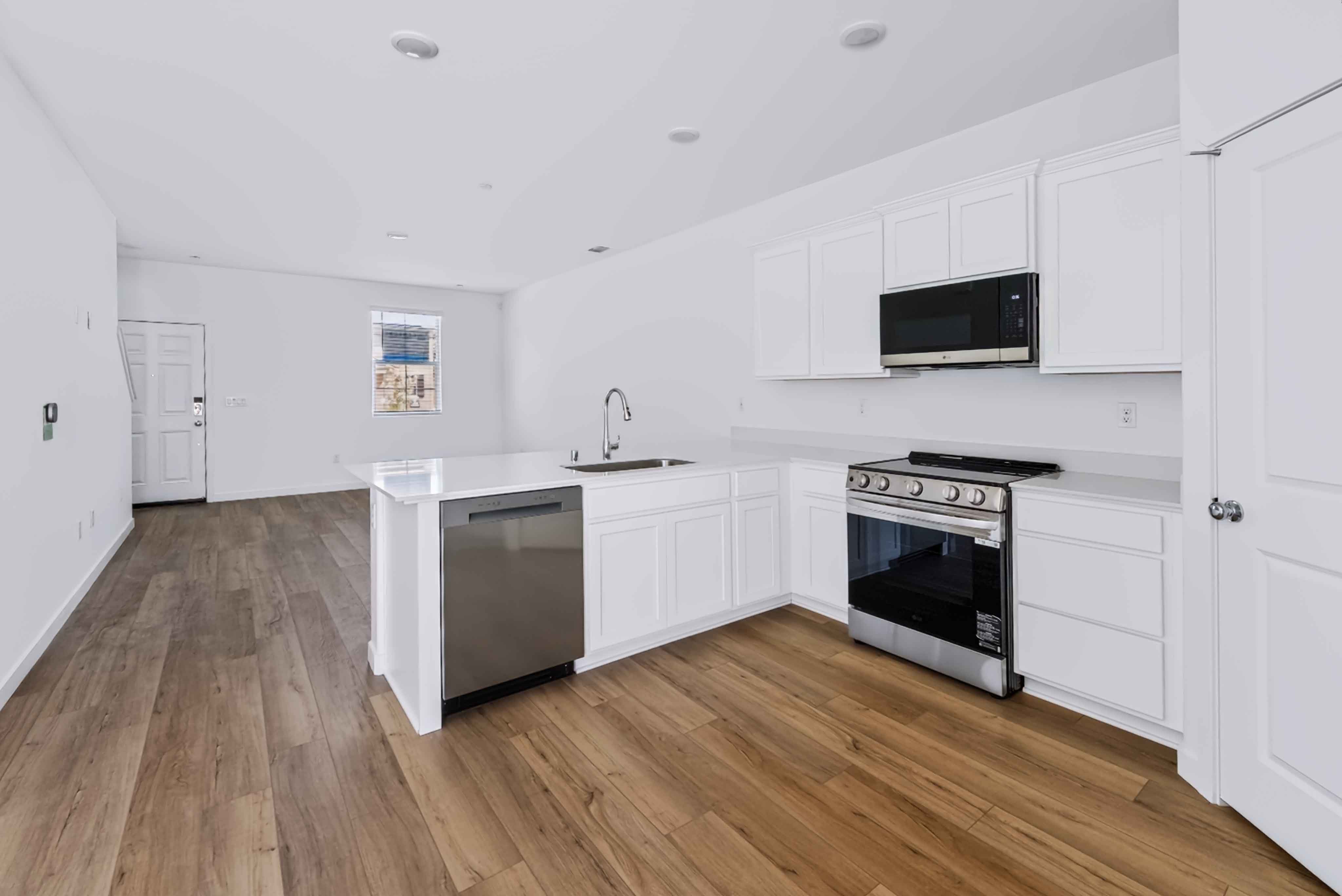 A kitchen with white cabinets.