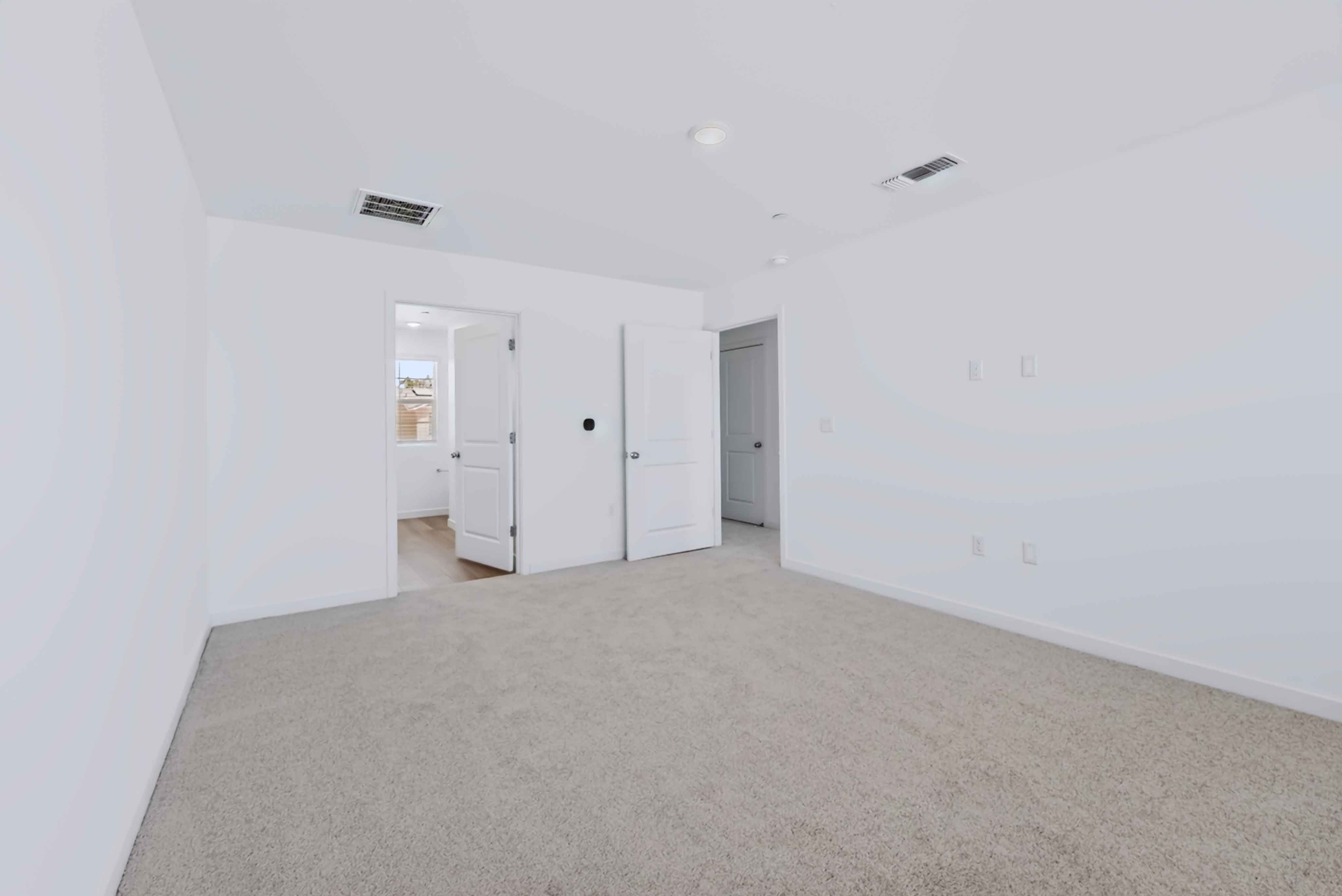 A hallway with white walls.