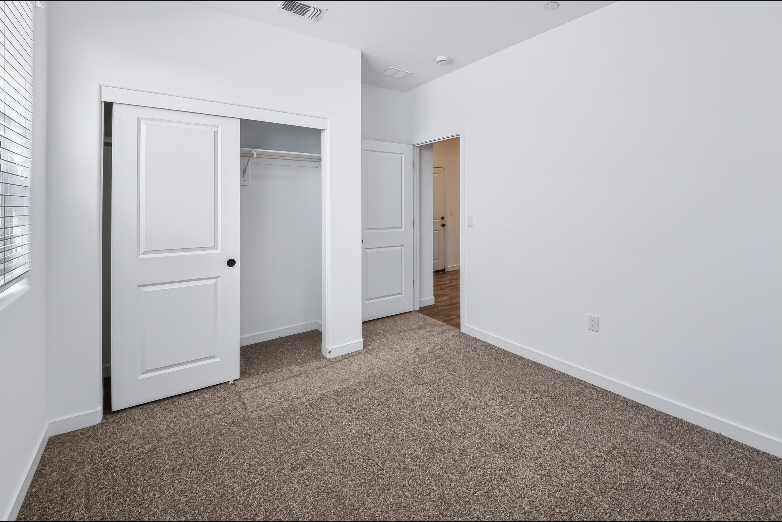 A hallway with white doors.