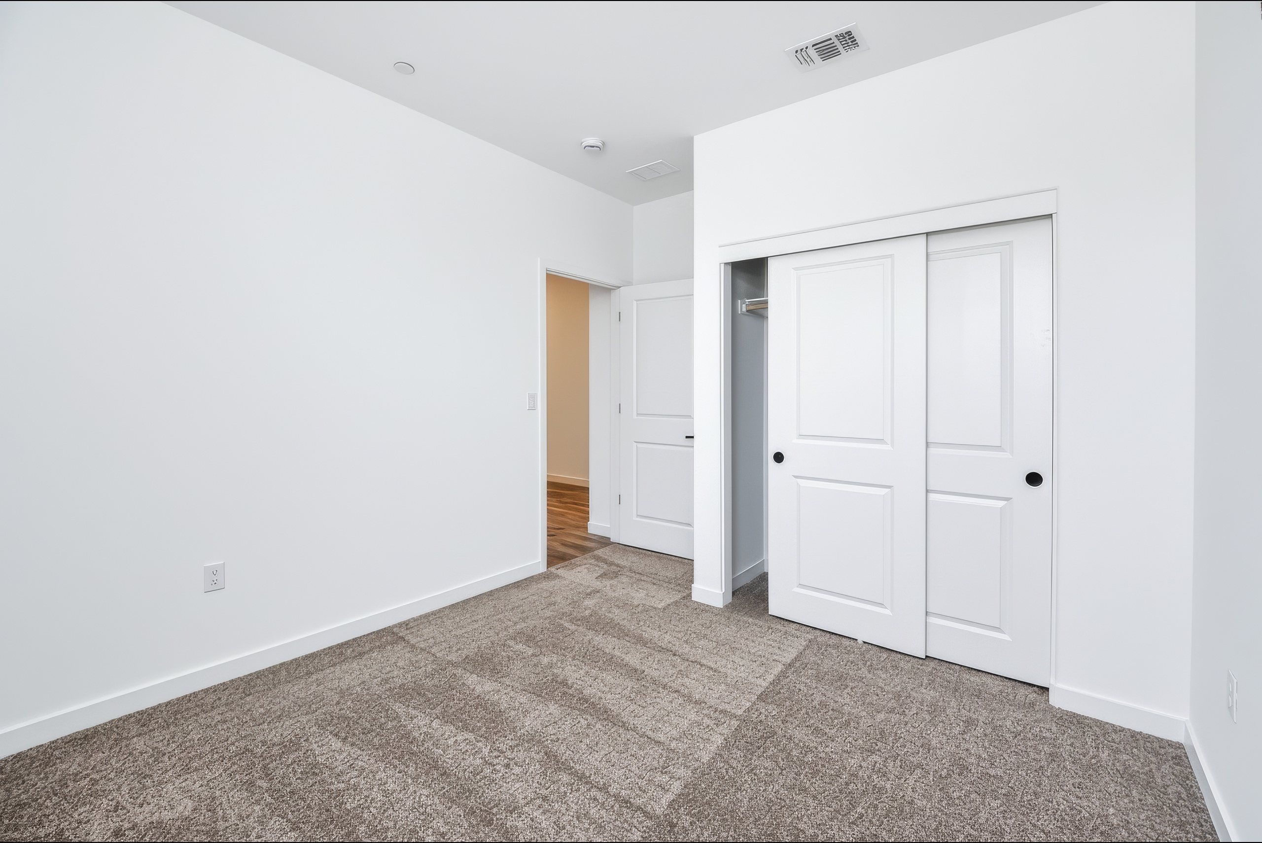 A hallway with white doors.