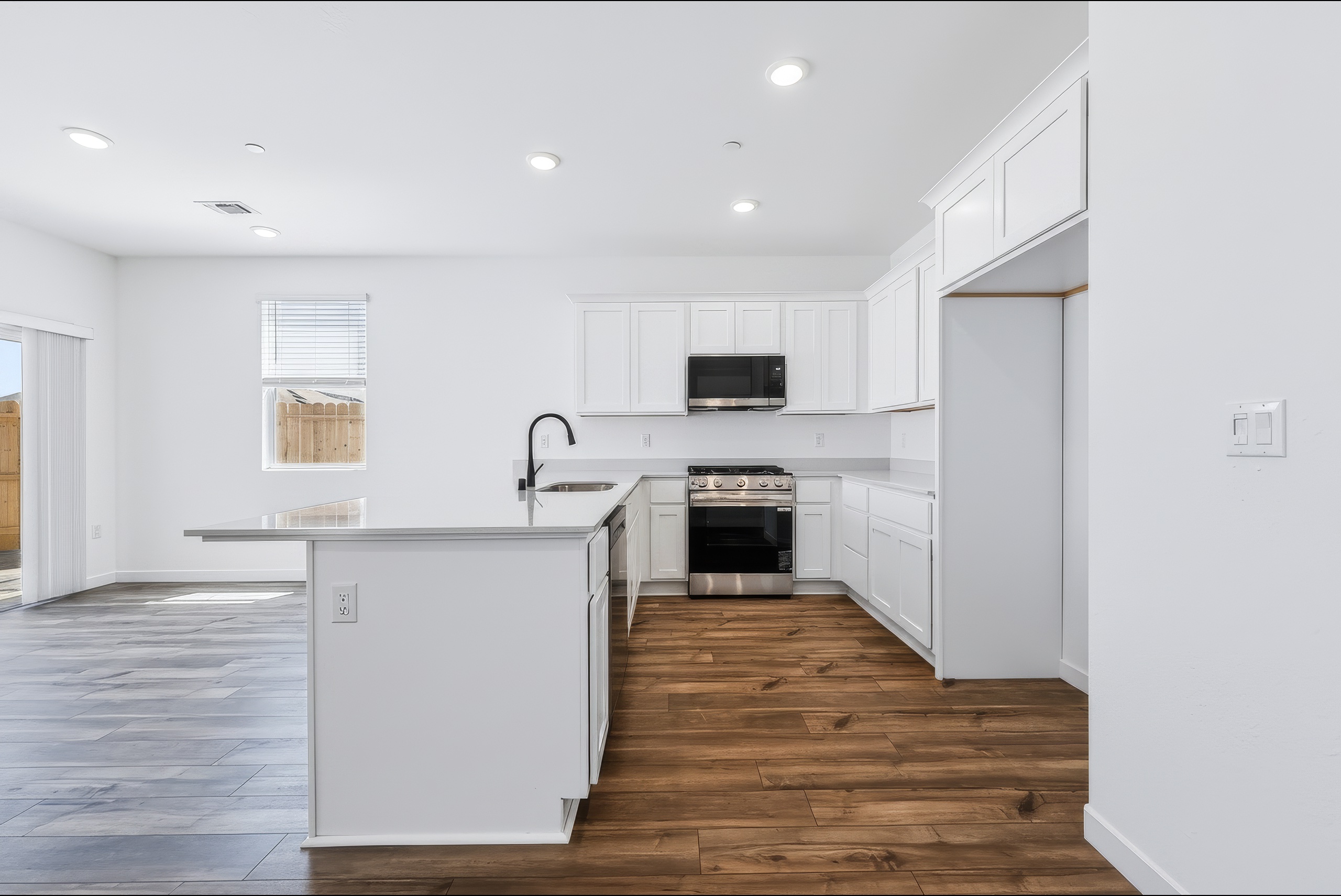 A kitchen with white cabinets.