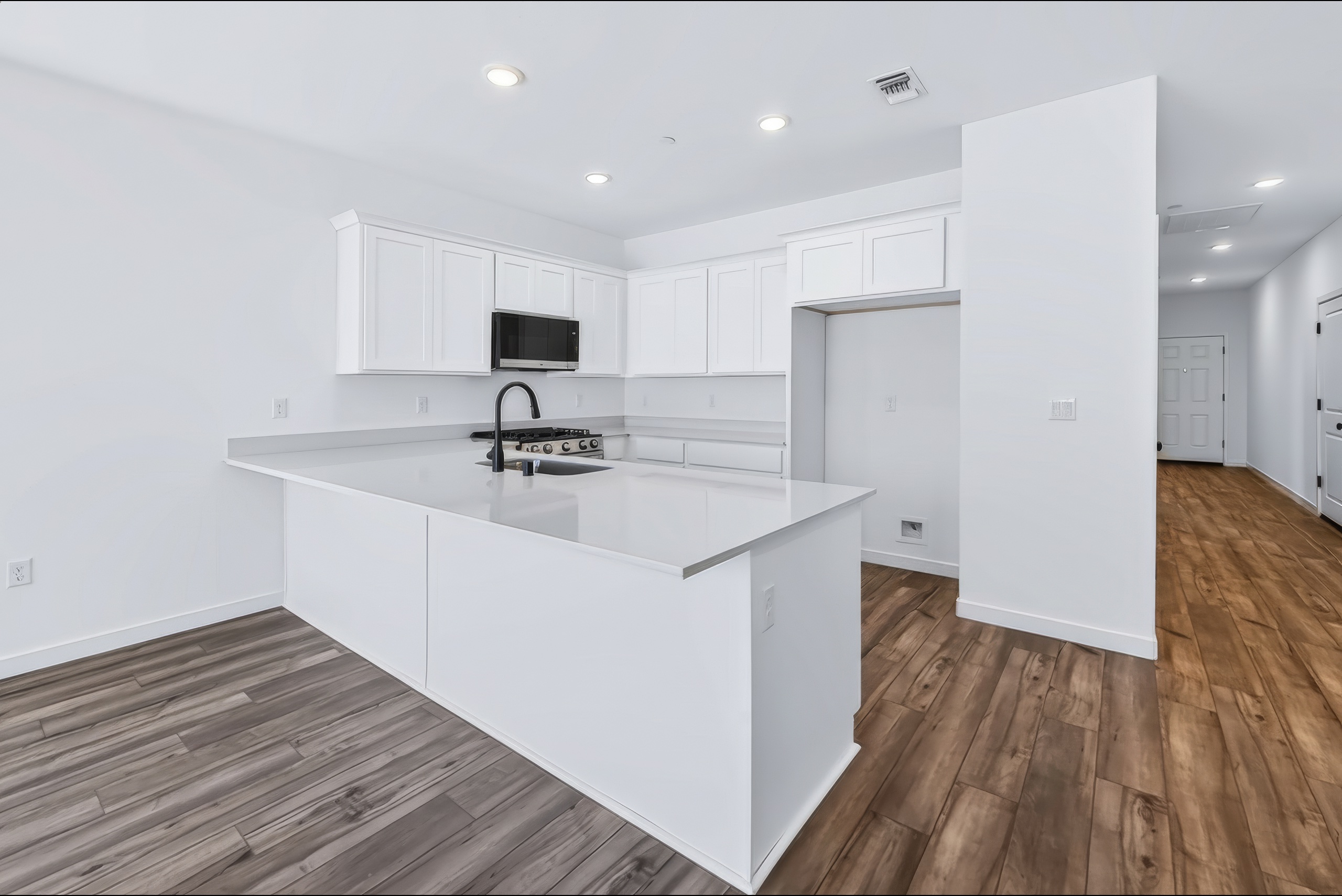 A kitchen with white cabinets.