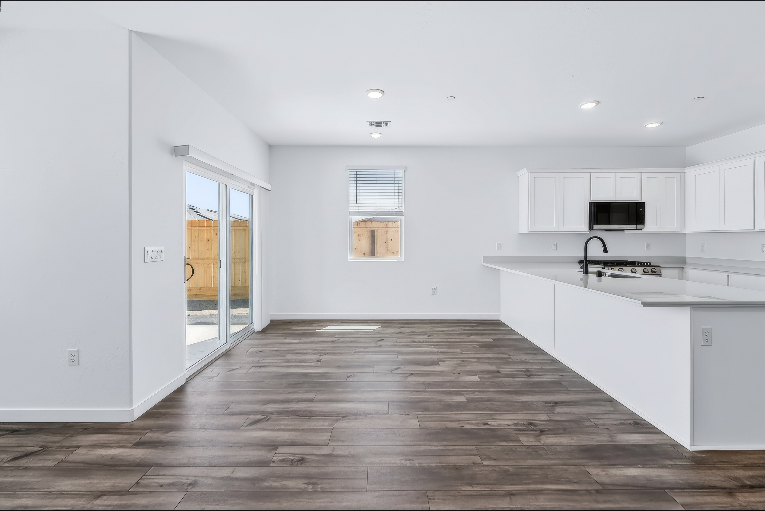 A kitchen with white cabinets.