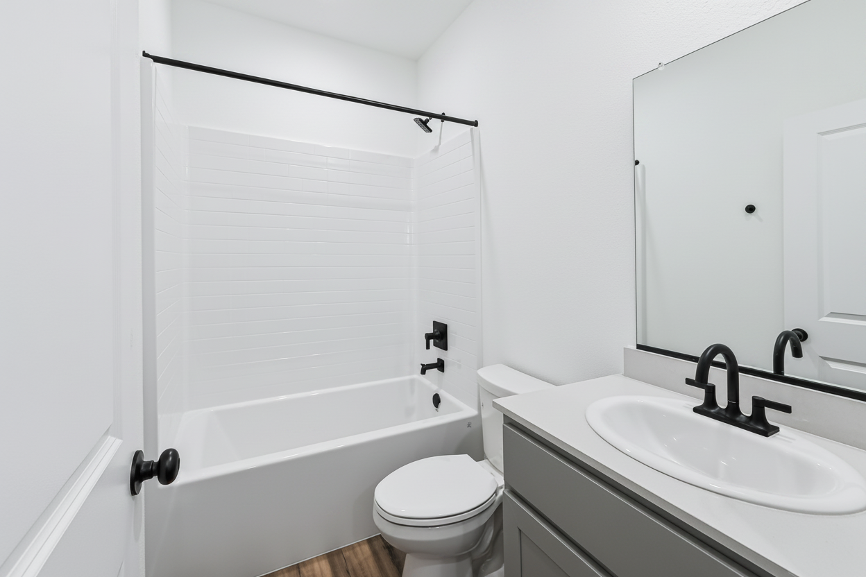 A bathroom with a sink and a toilet.