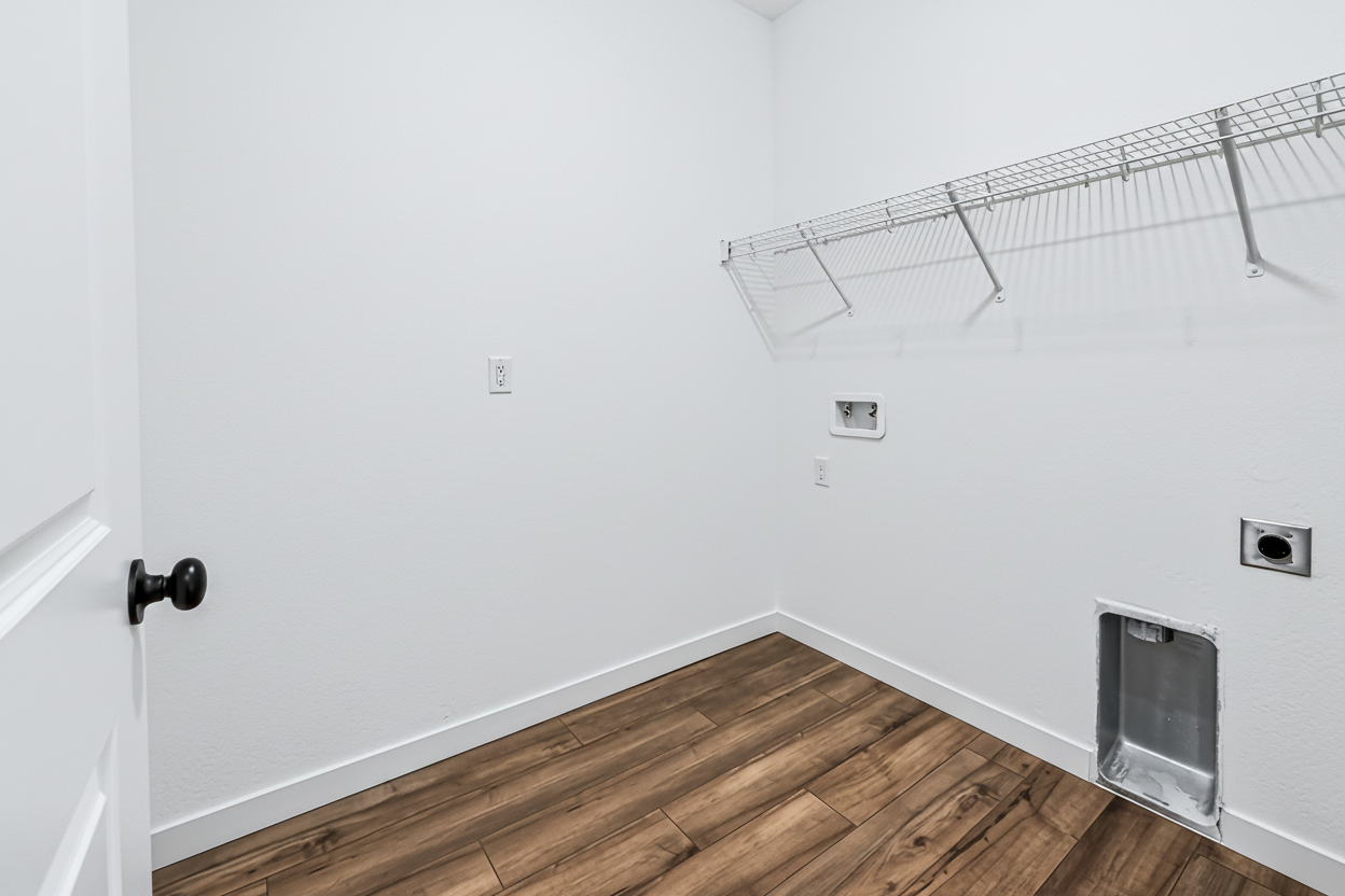 A room with a wood floor and a metal railing.
