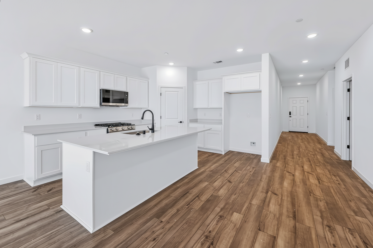 A kitchen with white cabinets.