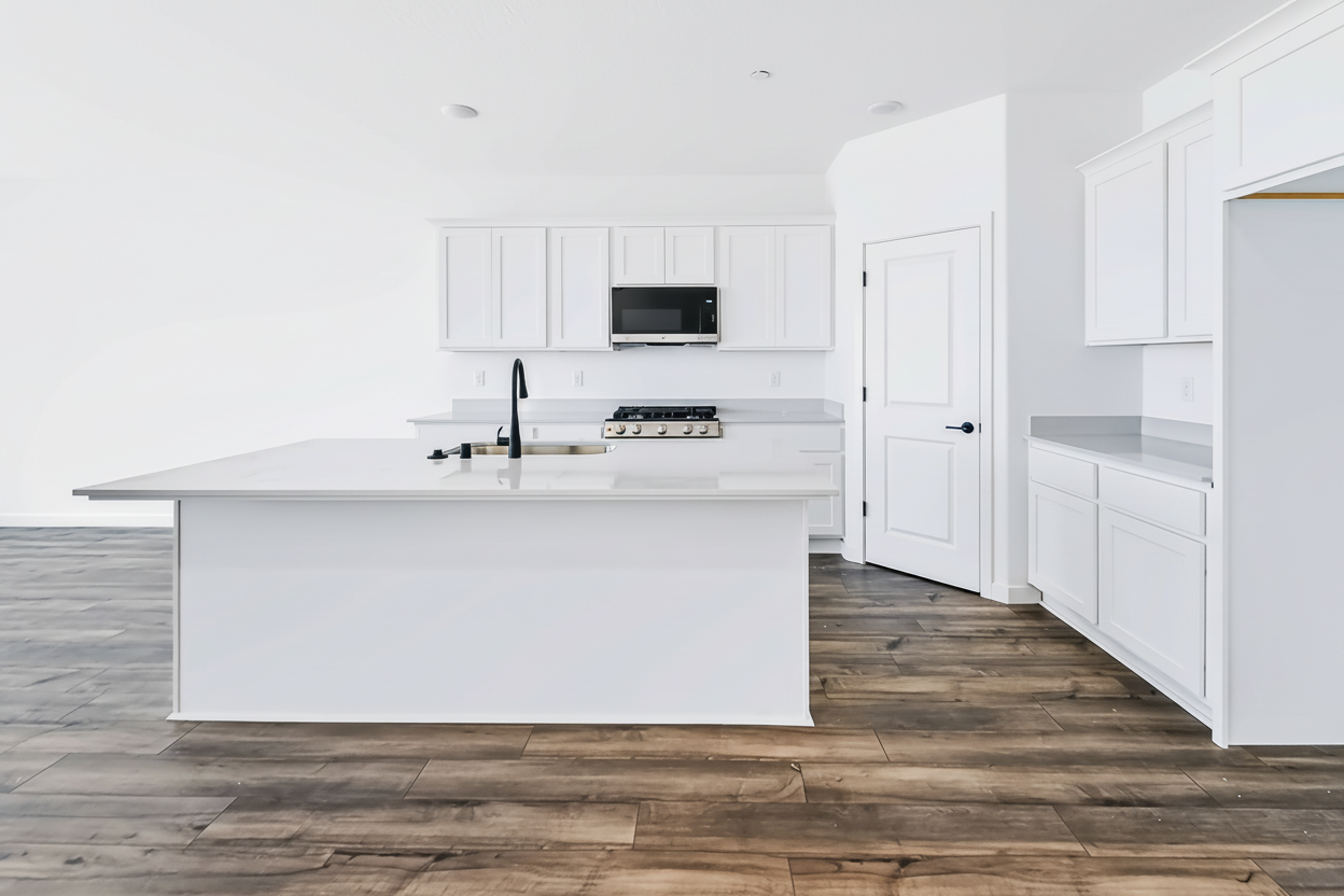 A kitchen with white cabinets.